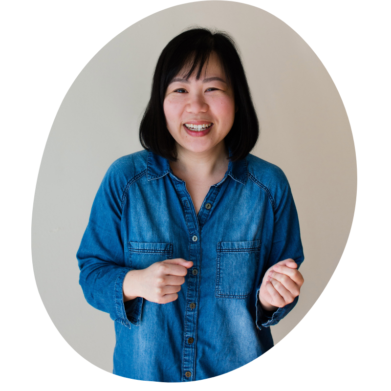 Crystal Lee pictured as a smiling Asian woman wearing a blue jean shirt
